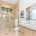 Modern bathroom with glass shower, wooden cabinets, and sleek fixtures in a bright, minimalist design
