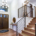 Chic entrance foyer with high ceiling and wide staircase with lights and contemporary railing