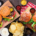 BBQ table scene with hamburgers, classic salads and snacks over dark wood stock photo
