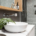 Bathroom details clean white basin with shower tiling behind stock photo