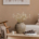 Natural-toned interior with rustic vase, textured pillows, and cozy lounge chair in a calm neutral setting stock photo